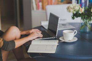 Woman on computer with a cup of tea